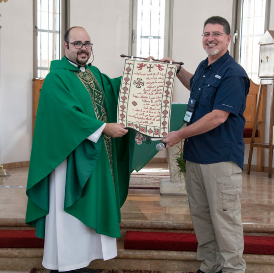 Father Jamil Monir Khadir presents Ben Trawick a needlepoint of the Lord’s Prayer made by the ladies of the church at the Church of the Good Shepherd in Rafidia, Palestine.