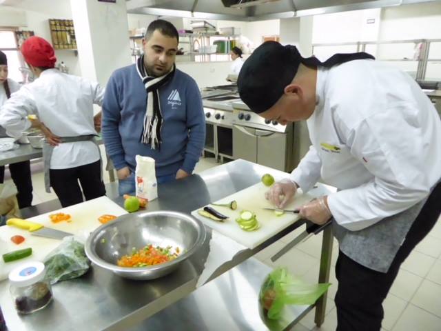 An instructor advises a culinary arts student at ETVTC.